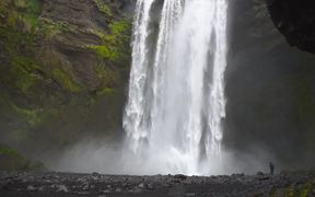 Man At the Base of Large Waterfall - Fun - VIDEOTIME.COM