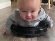 Baby Riding An Automatic Home Cleaning Machine