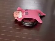Toddler Enjoying A Ride On A Vacuum Cleaner