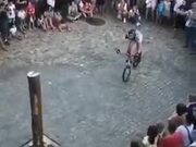 Cyclist Climbing A Pole On A Cycle