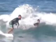 Surfer Encourages Younger Surfer To Take The Wave
