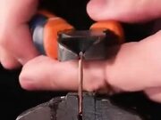 Slow Motion Zoomed Footage Of Wire Being Cut