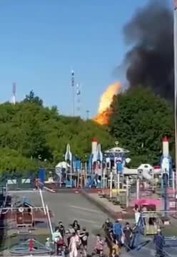 People Casually Walking Away From A Giant Fire