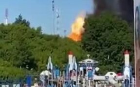 People Casually Walking Away From A Giant Fire
