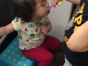 Big Brother Helps Little Sister Brush Teeth