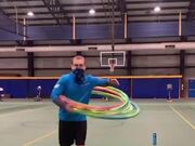 Man Throws Ball Into Basketball Hoop
