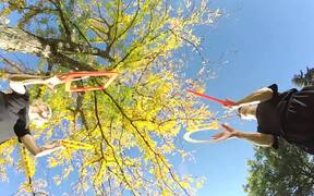 Duo Juggles Rings and Square Frames Beneath Tree - Fun - VIDEOTIME.COM
