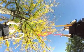 Duo Juggles Rings and Square Frames Beneath Tree - Fun - Videotime.com