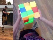 Person Solves Giant Rubik's Cube On Unicycle
