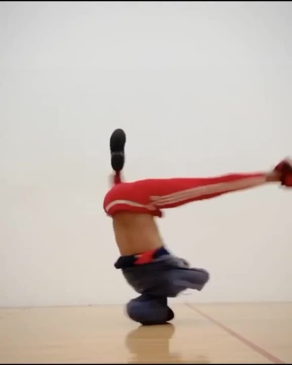 Guy Performs Multiple Headspins and Tricks