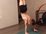Little Boy Performs Hand Stand On One Hand