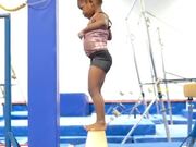Little Girl Walks On Gymnastic Balance Beam