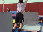 Athlete Performs 360 Spins on High Bar in Gym