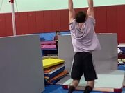 Athlete Performs 360 Spins on High Bar in Gym