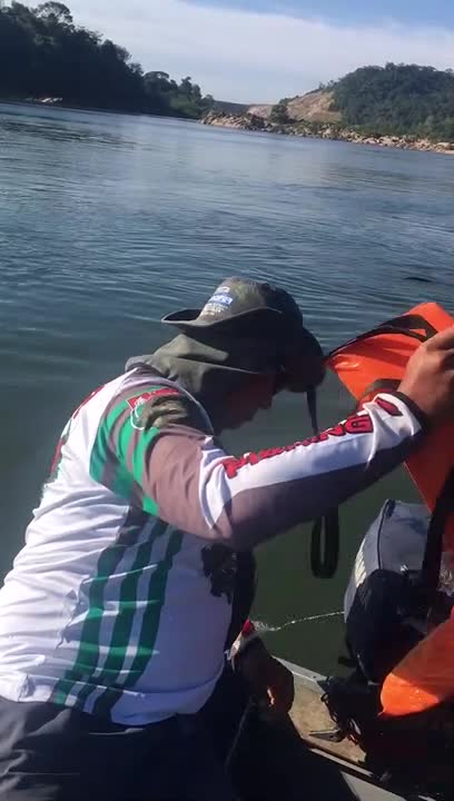 Men in Boat Rescue Monkey with Life Jacket