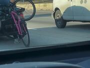 Bicycle Rides Behind Car on Highway