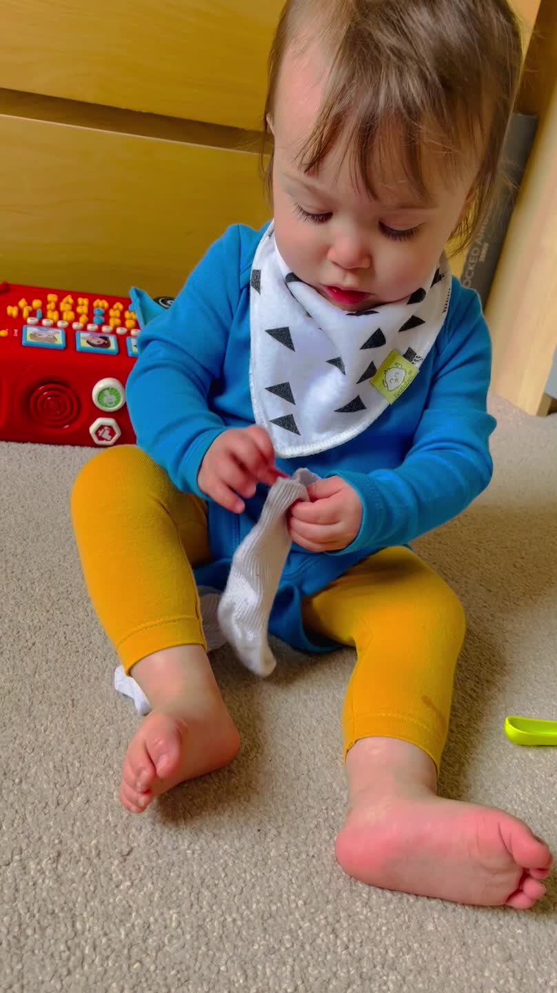A Baby Struggles BIG TIME With Putting A Sock On 