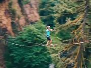 Guy Goes Slacklining Between Two Cliffs in Forest
