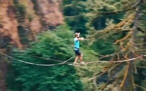 Guy Goes Slacklining Between Two Cliffs in Forest - Fun - VIDEOTIME.COM