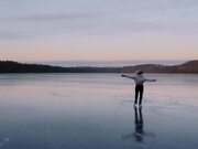 Figure Skater Performs on Frozen Lake