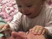 Baby Playfully Attempts to Put Pacifier