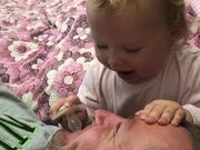 Baby Playfully Attempts to Put Pacifier