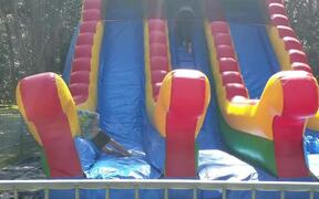 Kid Bounces Side To Side on Inflatable Slide - Kids - VIDEOTIME.COM