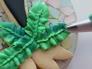 Person Decorates Cookie in Tropical Theme