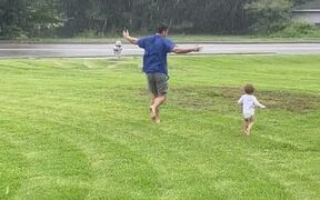 Dad and Toddler Dances Together in Rain