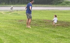 Dad and Toddler Dances Together in Rain - Kids - VIDEOTIME.COM