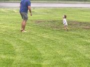 Dad and Toddler Dances Together in Rain