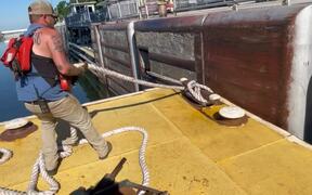 Strong Tugboater Stopping A Flat-Bottomed Boat