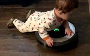 Little Boy Lays on Robot Vacuum Cleaner  - Kids - VIDEOTIME.COM