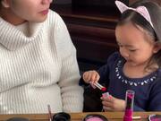 Little Girl Applies Makeup on Mom's Face