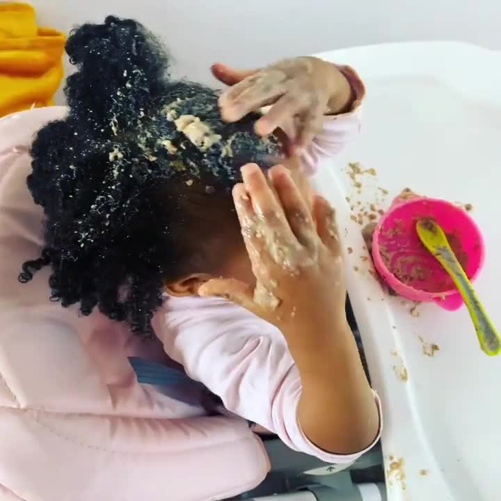 Toddler Applies Baby Food on Her Hair and Face