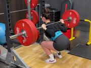 Girl Trying To Squat While Holding a Heavy Barbell