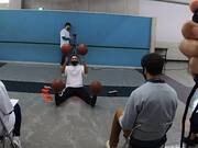 Freestyle Basketball Player Balances Four Balls