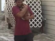 Man Rescues Cat Stuck in Flood
