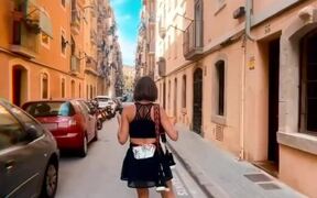 Woman Skates Down Narrow Street With Ease