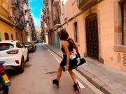 Woman Skates Down Narrow Street With Ease