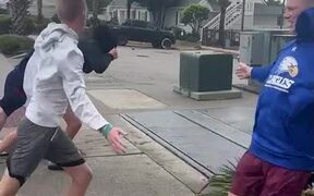 Group of Guys Try to Walk Against Strong Winds