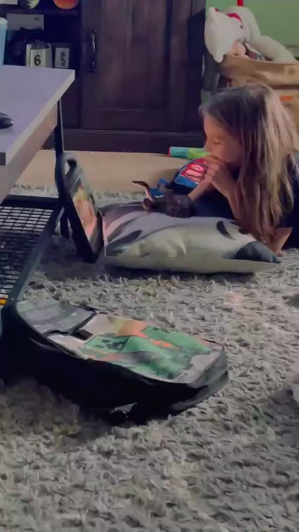 Girl Watches Television With Pet Snake