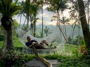 Man Chilling in a Hammock with Pet Python