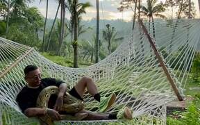 Man Chilling in a Hammock with Pet Python - Animals - VIDEOTIME.COM