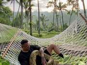 Man Chilling in a Hammock with Pet Python