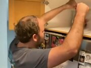 Man Fails to Capture Mouse Hiding Inside Cabinet