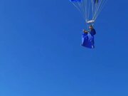 Person Sky Dives Through Rocky Desert