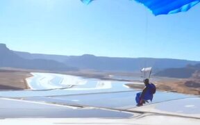Person Sky Dives Through Rocky Desert - Sports - VIDEOTIME.COM