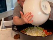 Toddler Actively Participates in Cooking Turkey