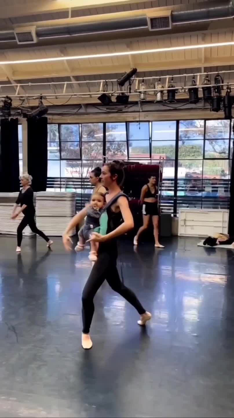  Woman Practices Ballet While Holding Her Baby